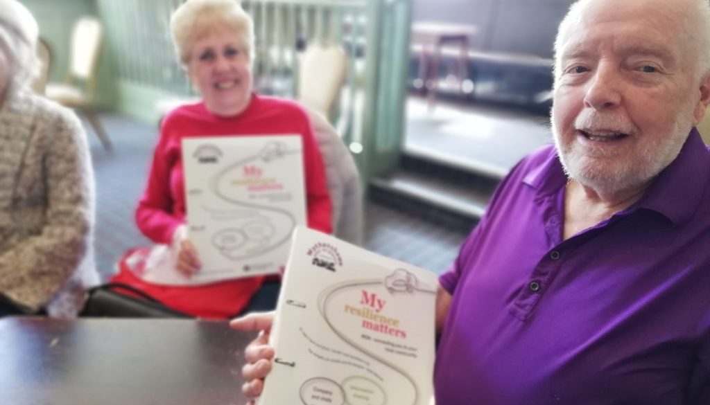 Wythenshawe Good Neighbours Members and Volunteer receiving their new resilience resource folder.