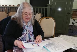 A Wythenshawe Good Neighbours Member looks through her new 'My resilience matters' resource folder. 
